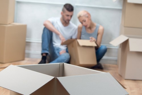 Student packing fragile items for a move in Kingscross
