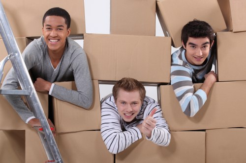 Professional movers handling furniture with a van in Kings Cross