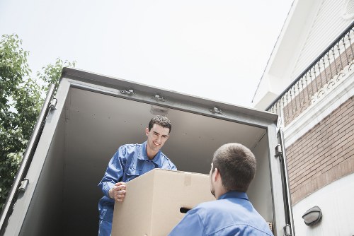Packed moving boxes and furniture ready for a removal van in Kingscross